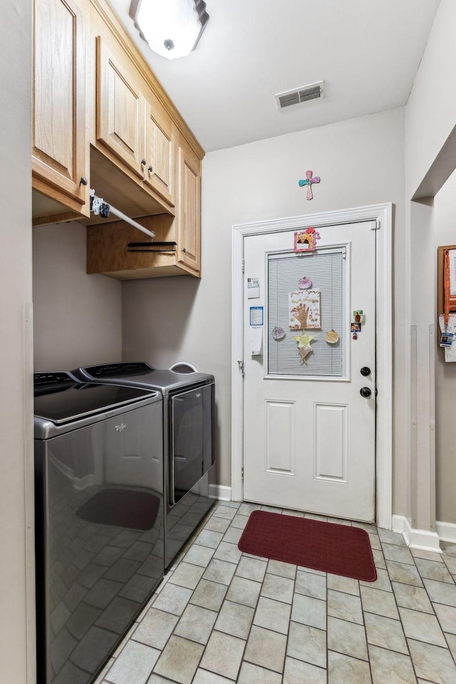 laundry area featuring cabinets and washer and dryer