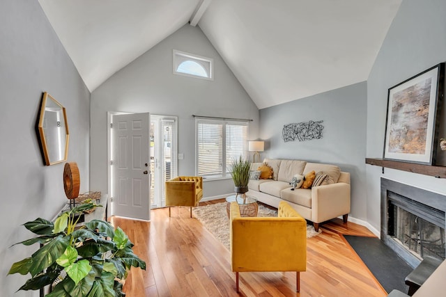 living room featuring hardwood / wood-style flooring and lofted ceiling with beams