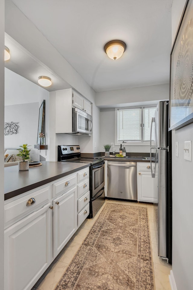 kitchen featuring white cabinets and appliances with stainless steel finishes