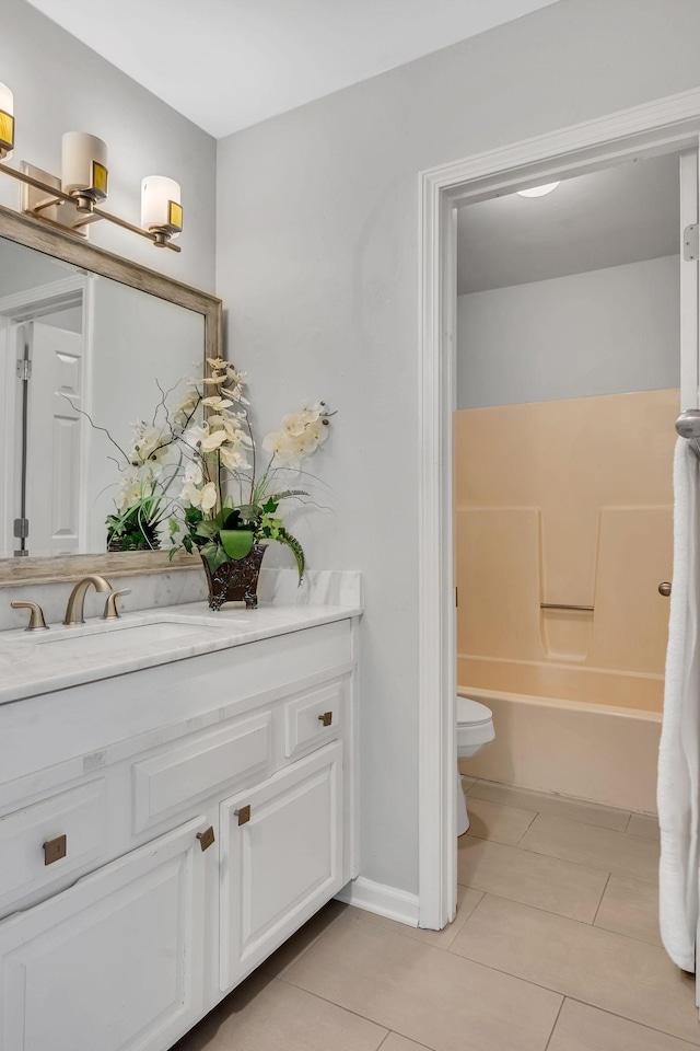 full bathroom featuring toilet, tile patterned floors, vanity, and shower / bathing tub combination