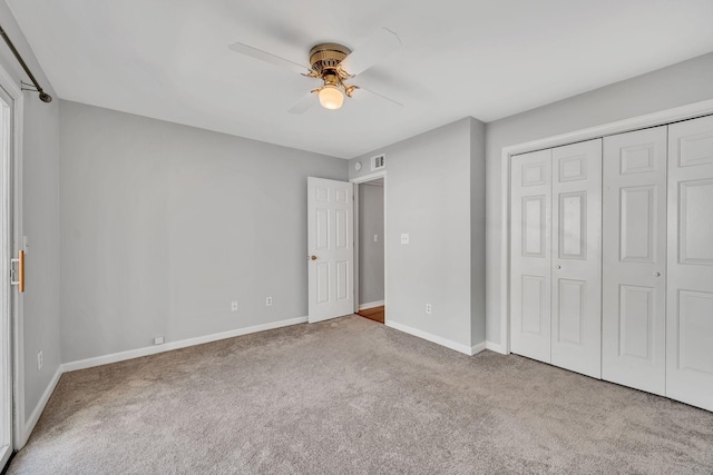 unfurnished bedroom with ceiling fan, a closet, and carpet flooring