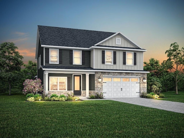 view of front of property featuring a garage and a lawn