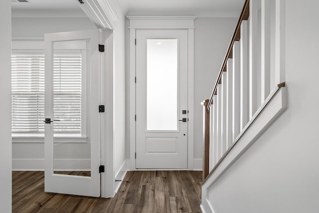 entryway featuring dark wood-type flooring and ornamental molding