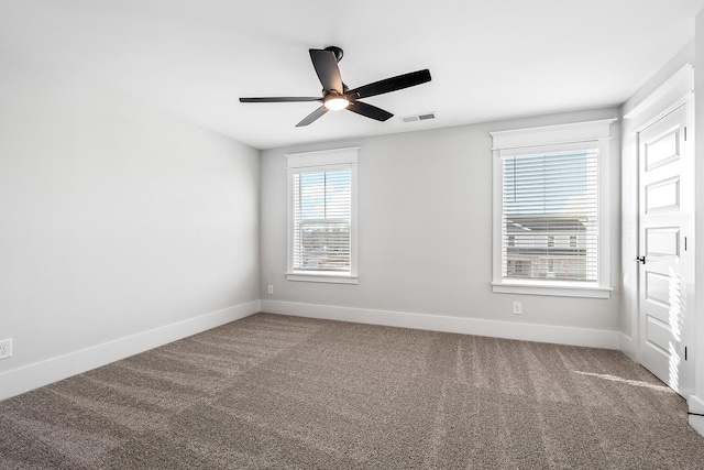 unfurnished room featuring ceiling fan and carpet flooring