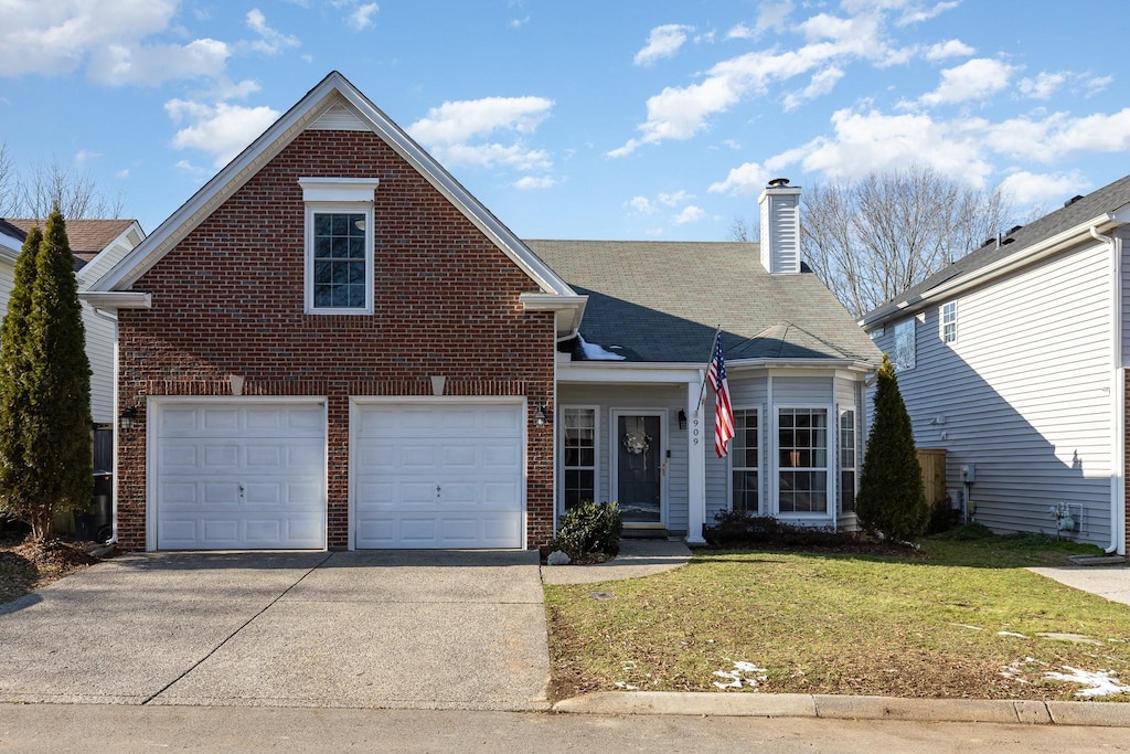 front facade featuring a front yard and a garage