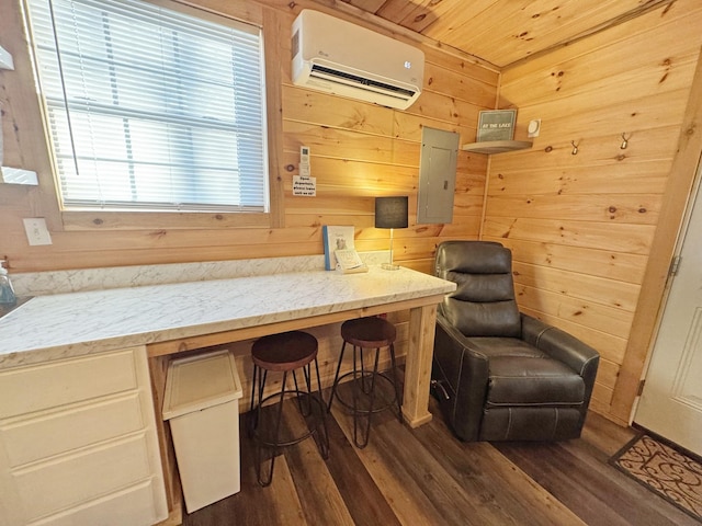 living area with an AC wall unit, dark hardwood / wood-style floors, wood walls, and electric panel