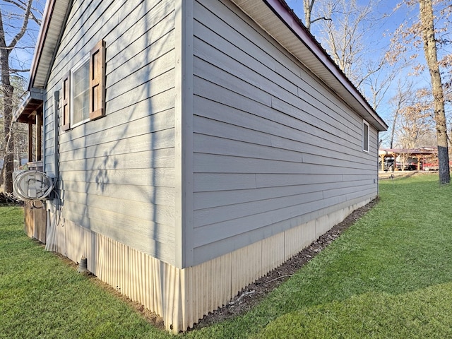 view of side of home featuring a lawn