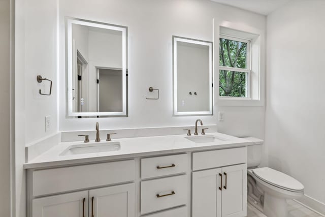 bathroom with toilet and vanity