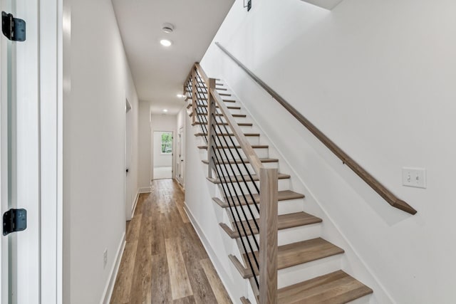 staircase with hardwood / wood-style flooring