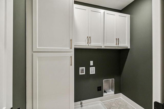 laundry area featuring hookup for a washing machine and cabinets