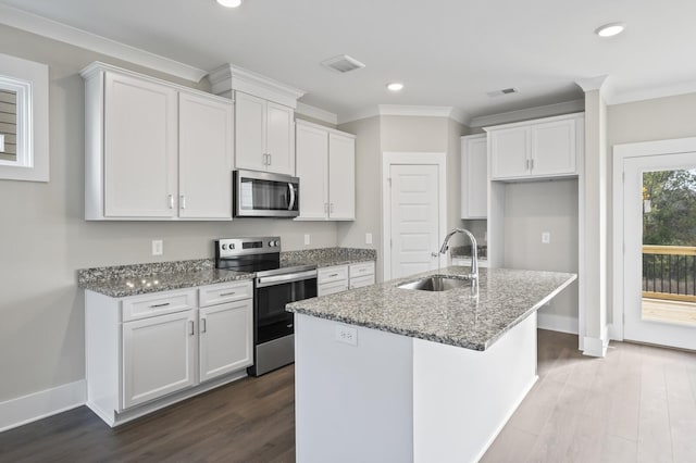 kitchen with stone counters, sink, a kitchen island with sink, stainless steel appliances, and white cabinets