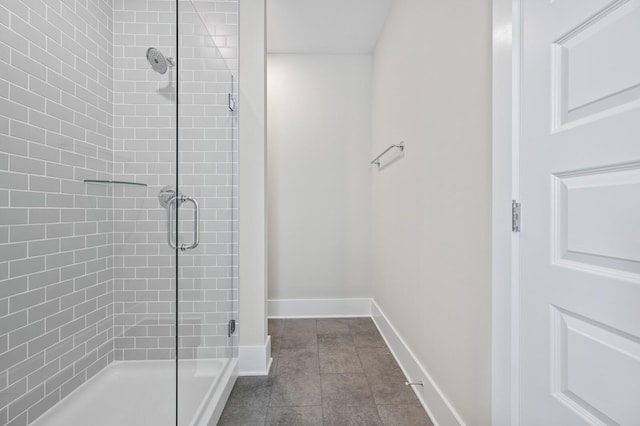 bathroom featuring tile patterned floors and a shower with door