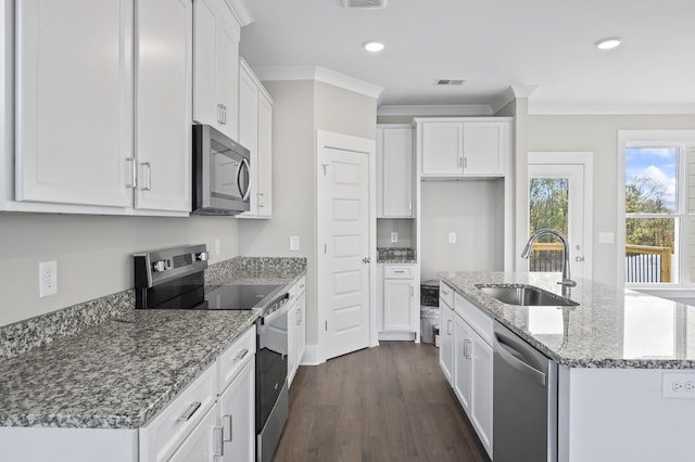 kitchen with white cabinets, sink, light stone counters, and stainless steel appliances