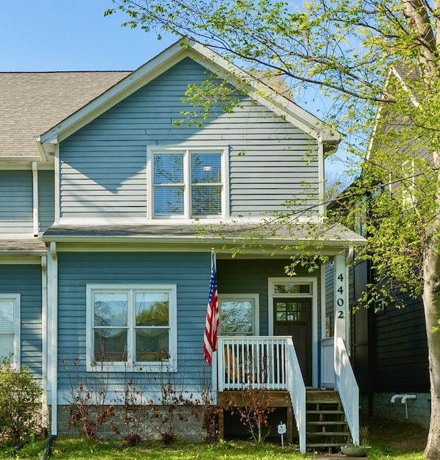 back of property with a porch