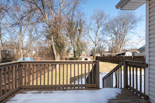 snow covered deck featuring a lawn