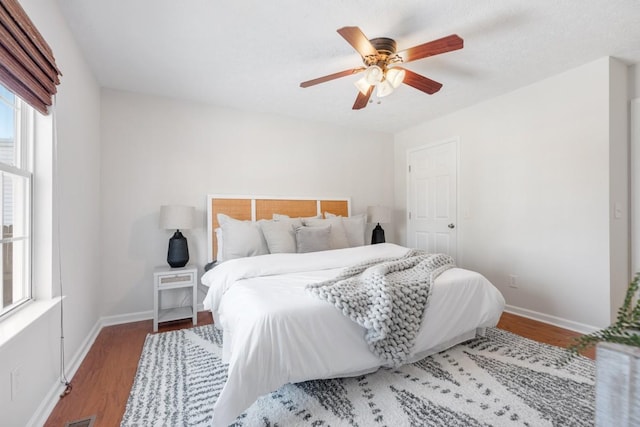 bedroom with ceiling fan and hardwood / wood-style flooring