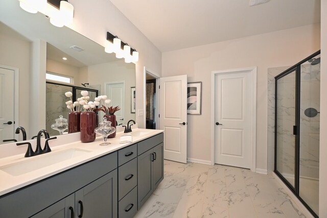 bathroom with a shower with shower door and vanity