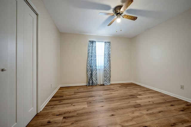 unfurnished bedroom featuring ceiling fan and light hardwood / wood-style flooring