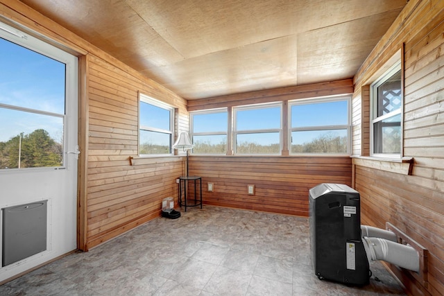 unfurnished sunroom with lofted ceiling and wood ceiling