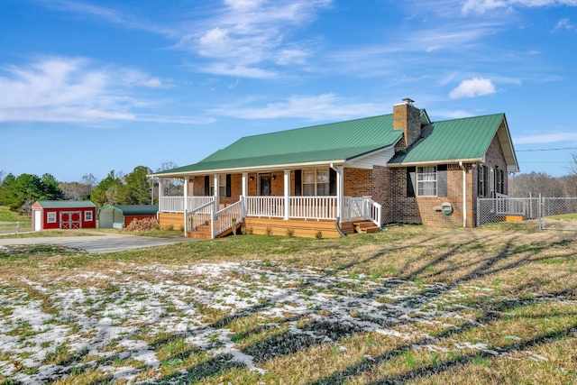 view of front of house featuring a storage unit and covered porch