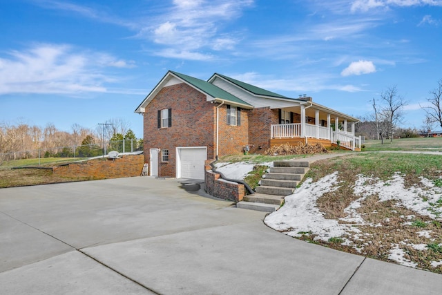 view of side of home featuring a garage and a porch