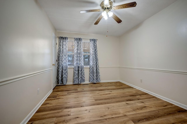 spare room featuring light hardwood / wood-style floors and ceiling fan