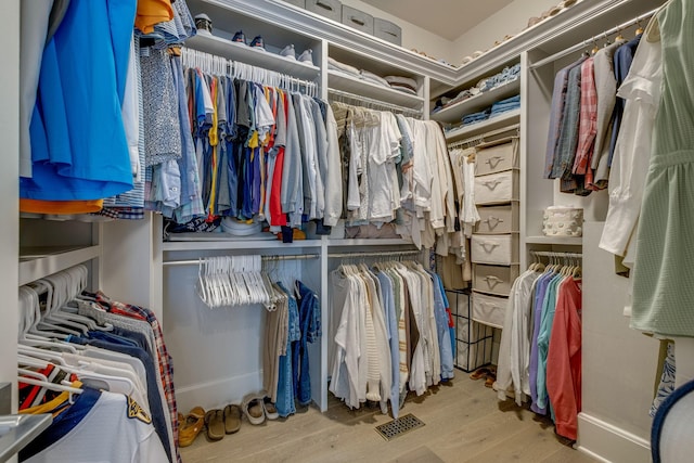 walk in closet featuring light hardwood / wood-style flooring