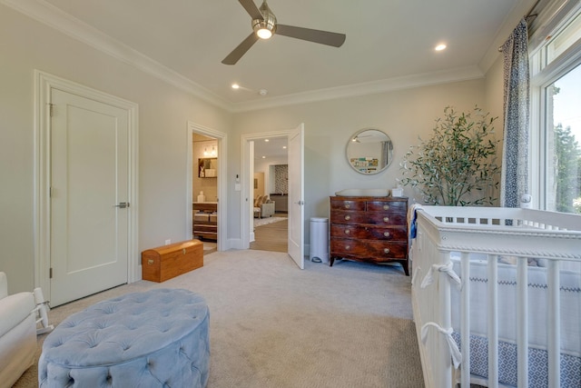 bedroom with ceiling fan, multiple windows, ensuite bathroom, and light carpet