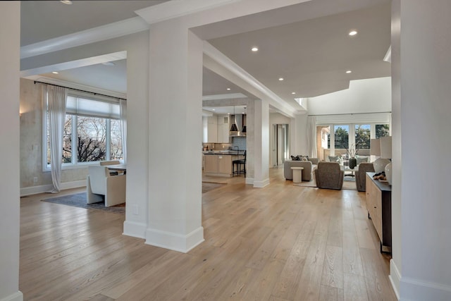 interior space with crown molding and light hardwood / wood-style flooring