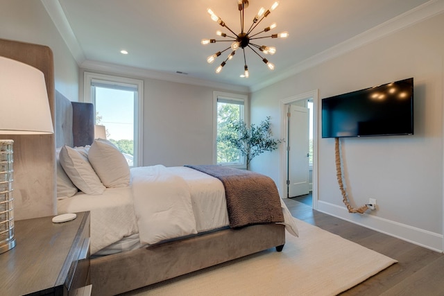 bedroom with wood-type flooring, ensuite bathroom, ornamental molding, and a chandelier