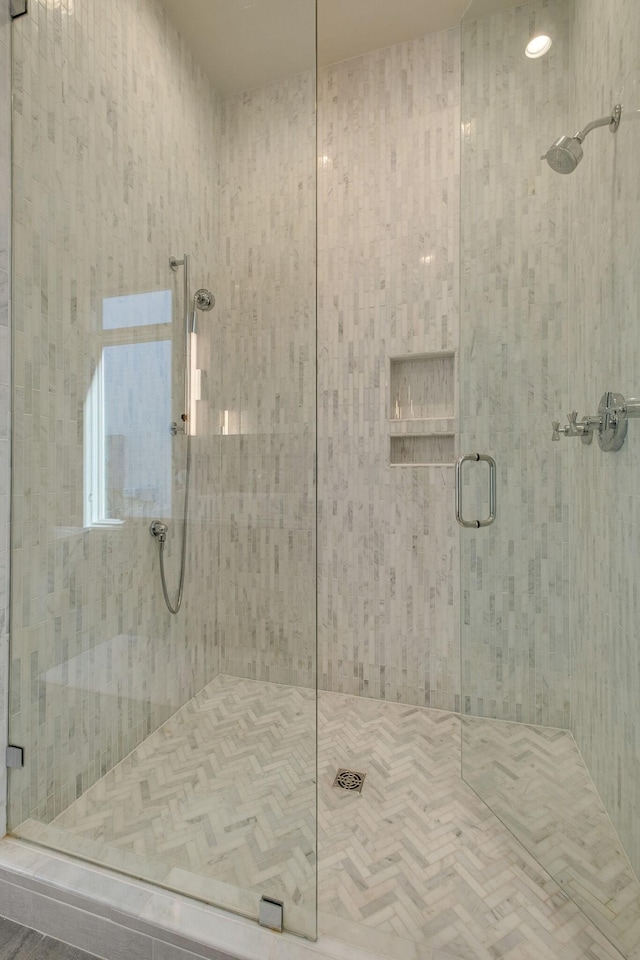 bathroom featuring a shower with door