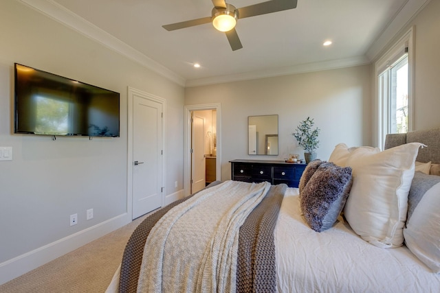 carpeted bedroom featuring ceiling fan, crown molding, and ensuite bathroom