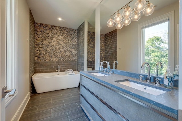 bathroom featuring a tub to relax in and vanity