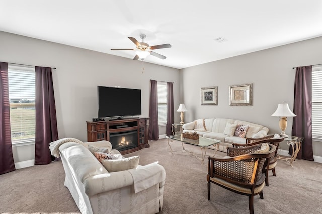 carpeted living room featuring ceiling fan