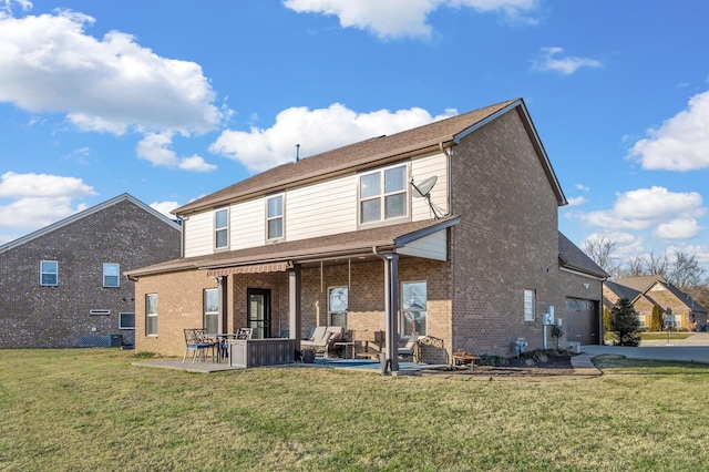 back of property featuring a lawn and a patio