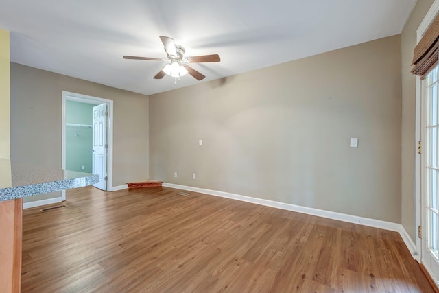 unfurnished room with ceiling fan and light hardwood / wood-style flooring