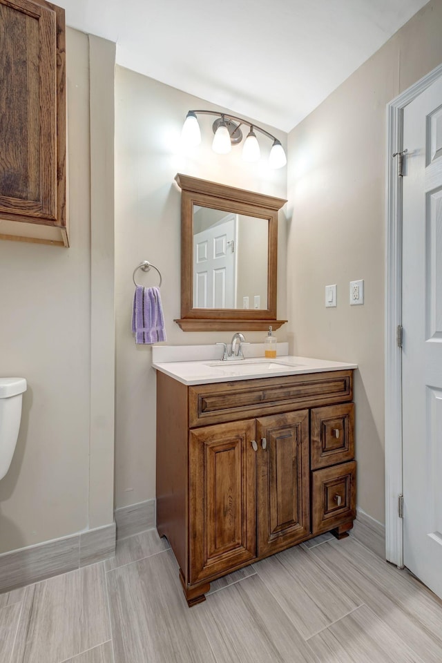 bathroom featuring toilet and vanity