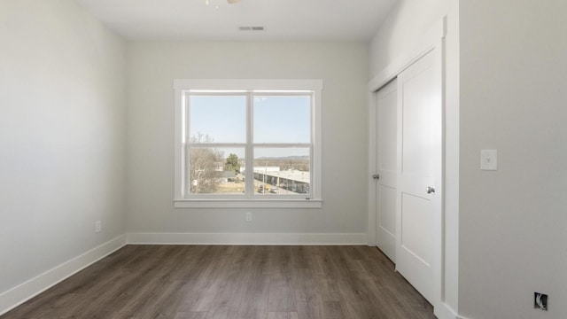 spare room with dark hardwood / wood-style flooring