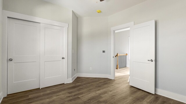 unfurnished bedroom featuring a closet and dark hardwood / wood-style floors