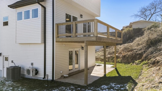 view of property exterior featuring a yard, central AC unit, ac unit, a deck, and a patio