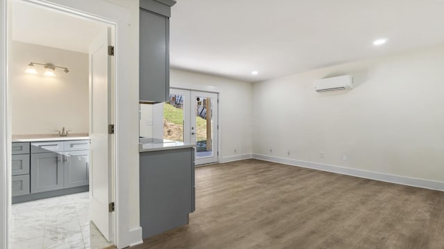 empty room with sink, french doors, and a wall mounted AC