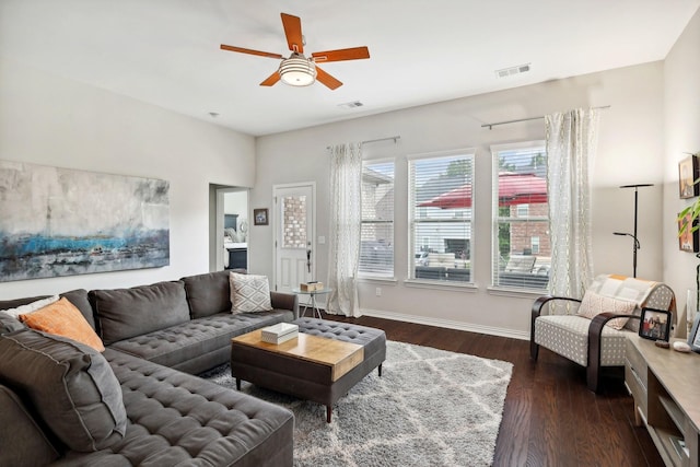 living room featuring ceiling fan and dark hardwood / wood-style flooring