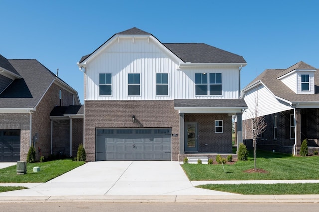 view of front of home with a front yard and a garage