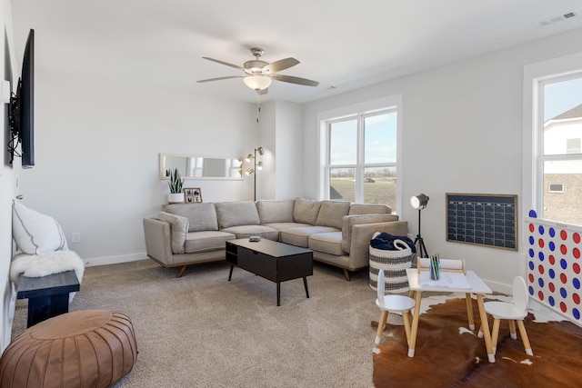 carpeted living room featuring ceiling fan