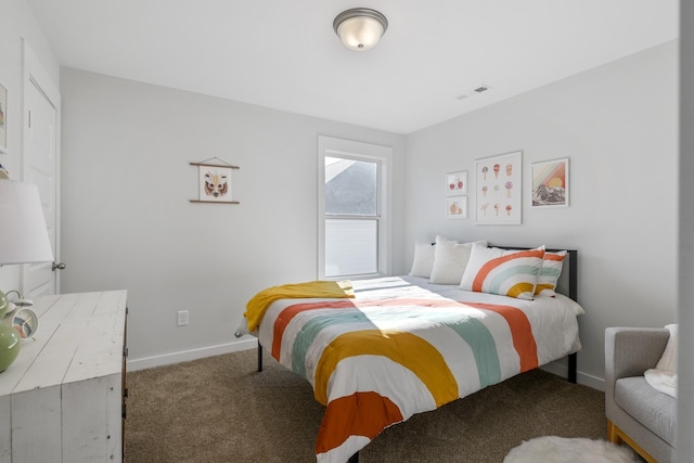 carpeted bedroom featuring visible vents and baseboards