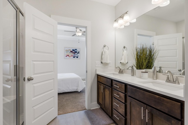 ensuite bathroom with a ceiling fan, a sink, ensuite bath, and double vanity