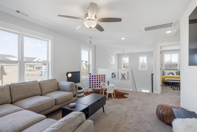 living room with carpet, visible vents, baseboards, and recessed lighting