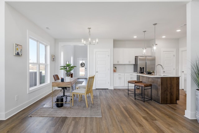 dining room with recessed lighting, dark wood finished floors, baseboards, and an inviting chandelier