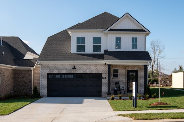 view of front of house with a front yard and a garage