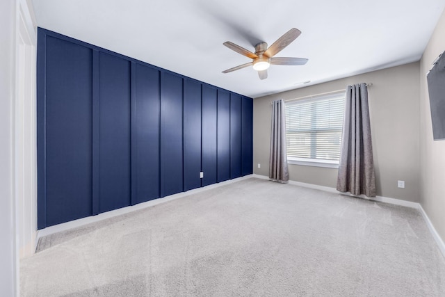 carpeted empty room featuring ceiling fan